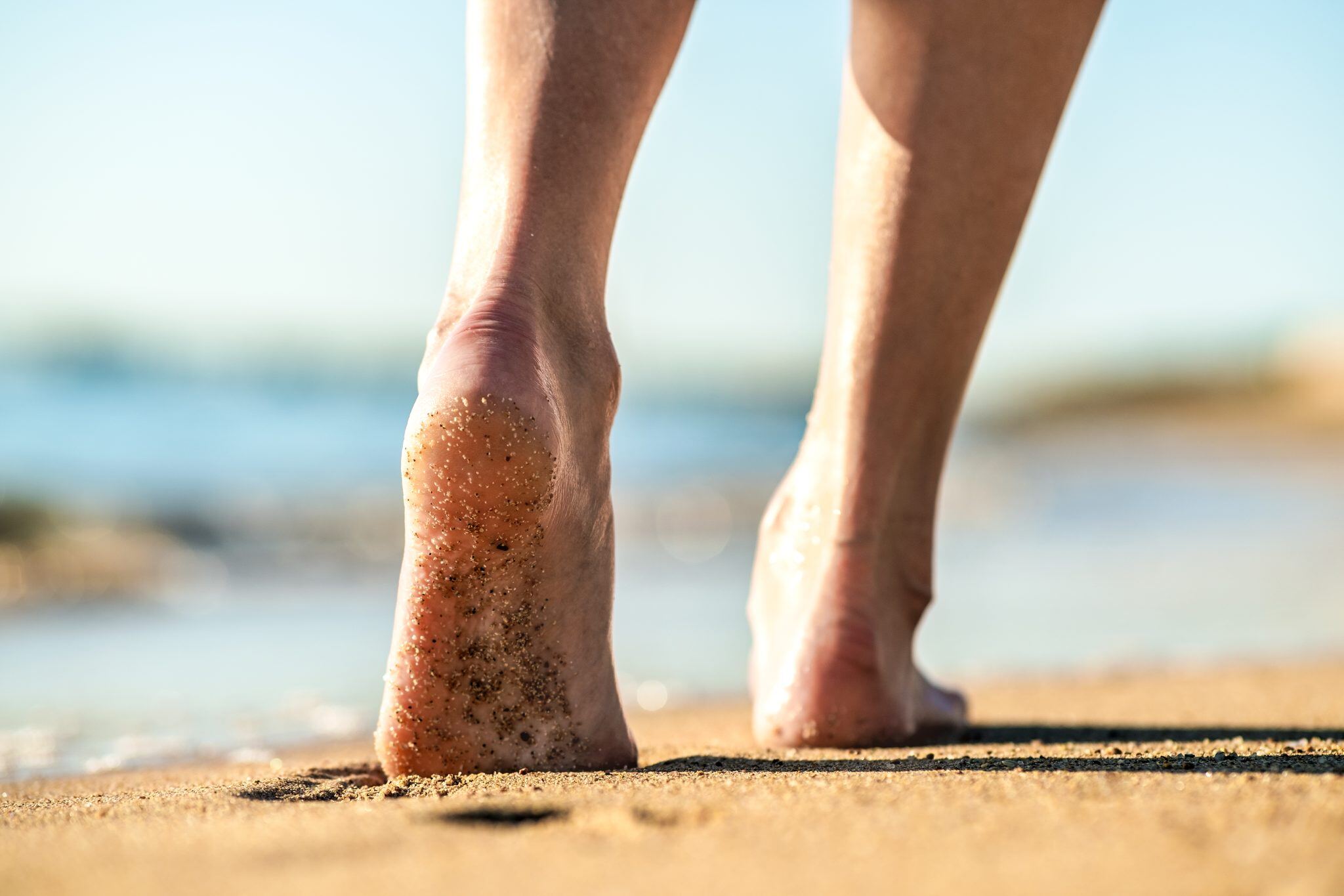 close-up-of-woman-feet-walking-barefoot-on-sand-le-2023-11-27-04-57-16-utc-2048x1365